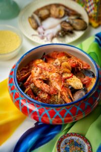 Sicilian seafood couscous with prawns, clams and mussels in a hand painted ceramic bowl at Mandorla, Chiang Mai
